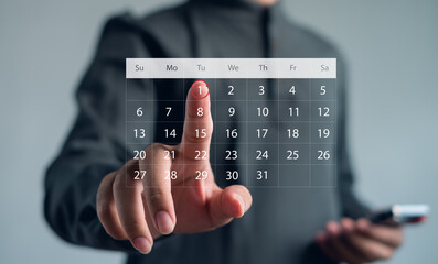Businessman touching virtual digital calendar interface to schedule and plan work. Concept for productivity, appointment, organization, planning, and modern business technology.