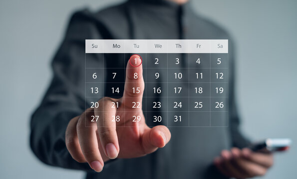 Businessman touching virtual digital calendar interface to schedule and plan work. Concept for productivity, appointment, organization, planning, and modern business technology.