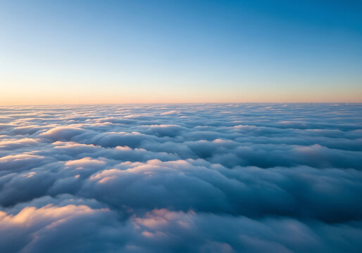 Aerial view of endless white clouds at sunrise with blue sky atmosphere