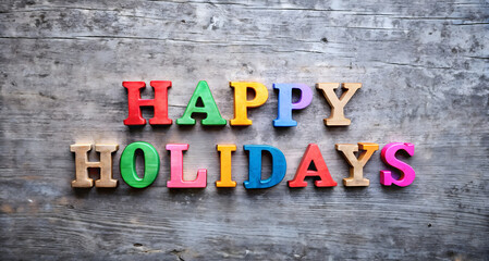 Colorful wooden letters spelling happy holidays