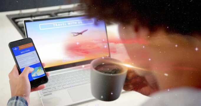 Man tapping phone while sipping coffee, checking fares as sparkles overlaying laptop travel screen