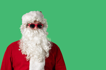 Close up portrait of Santa Claus with a white curly beard, wearing a red hat and suit, on a solid green chroma key background. Ideal for Christmas-themed compositions, advertising, and holiday mockups