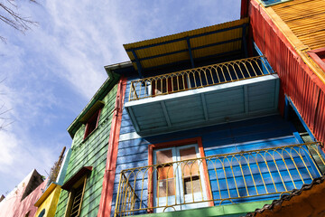 Photograph taken from below showing the characteristics of colorful buildings in the La Boca neighborhood of Buenos Aires, constructed from various materials