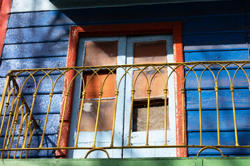 Close-up photograph of a balcony door in a colorful building