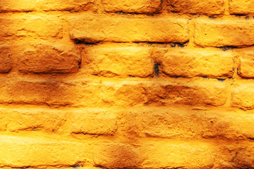 A brick wall painted yellow