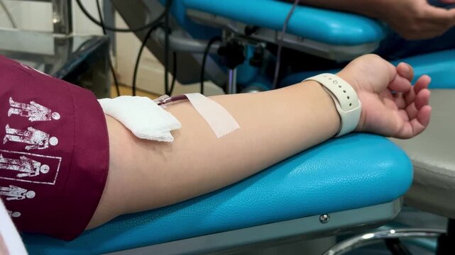 Close Up Shot Of female hand Blood Donor With an Attached Catheter. Donation For Organ Transplant Patients.