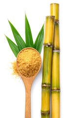 Cane stalks, sugar, leaves, and a wooden spoon on a white backdrop