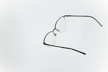 Stylish women’s eyeglasses with thin metal semi-rim frame on white background. Vsion correction concept.
