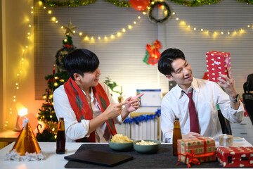 Christmas, gift and excited business people in office for holiday, tradition and celebration.