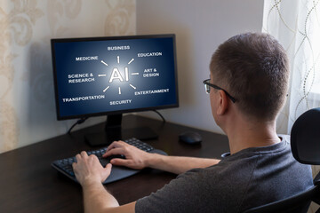 Remote work from home. Man seated at desk, engaging with computer screen displaying artificial intelligence applications across multiple sectors, including business, education, and entertainment