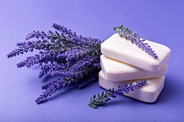 Lavender soap. Beauty and health. Stacked lavender soap bars are accompanied by fresh lavender sprigs, creating soothing and aromatic display on vibrant purple background