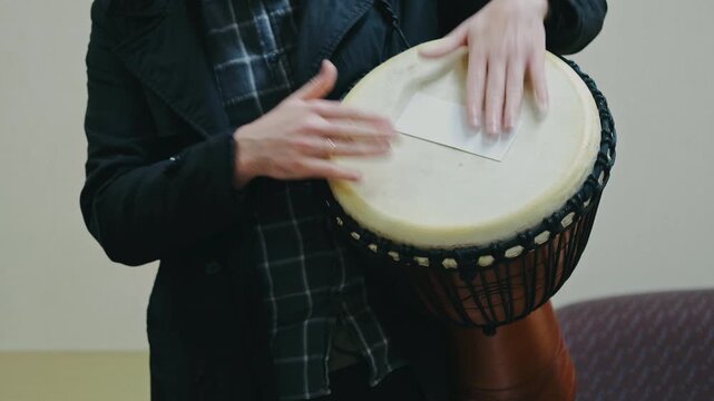 community participants collaboratively create rhythm around djembe in harmony and improvisation