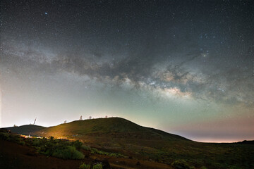 Stunning night sky over Mount Teide in Tenerife, Canary Islands. The Milky Way arches across the sky above the volcanic landscape of Teide National Park. A breathtaking astrophotography scene perfect 