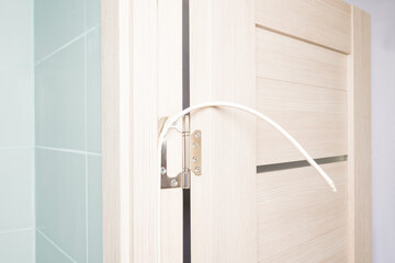 The master's hands install the rubber door seal, close-up