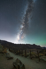 Stunning night sky over Mount Teide in Tenerife, Canary Islands. The Milky Way arches across the sky above the volcanic landscape of Teide National Park. A breathtaking astrophotography scene perfect 