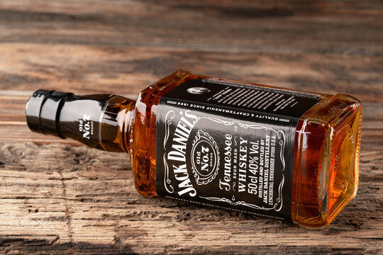 Bottle of whiskey Jack Daniels on wooden background