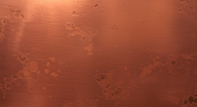Copper surface showing corrosion spots linear scratches and textural unevenness with varying tones