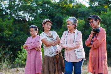 Naklejka premium Senior Asian women standing posing arms crossed cheerful smiling outdoor casual clothing nature vacation adventure travel leisure lifestyle freedom exploration friendship journey refreshing happiness