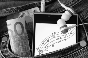 Headphones and a smartphone with an image of notes.
