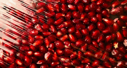 Juicy pomegranate seeds texture. plastic packaging