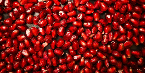 Juicy pomegranate seeds texture. Food ingredient background top view