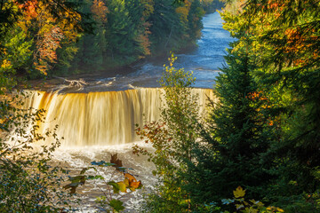 Elevated view of Tahquameon Falls surrounded by colorful trees.