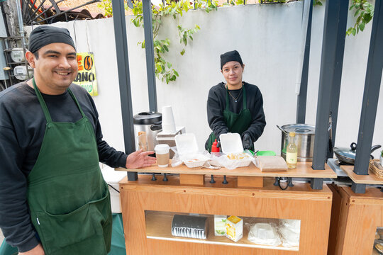 Smiling Baristas Serving Coffee and Breakfast at Street Café