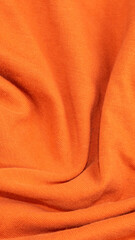 orange crinkled cotton fabric. background or textura