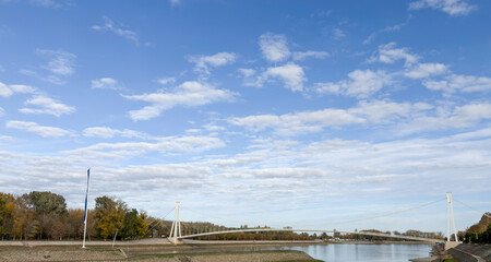 Osijek pedestrian bridge stretching across river under vast sky