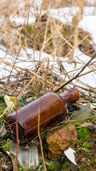 wild garbage dump. residual glass, plastics in the forest