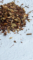 Herbal tea leaves on textured surface for relaxation and wellness concept of branding, tea shops, spa centers