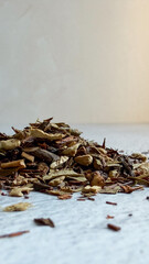 Assorted dried herbal tea leaves on light surface with copyspace - concept for tea shops, wellness brands, health product ads