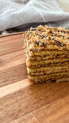 Close-up of layered crumb cake on wooden surface with linen background for bakery and dessert businesses concept of