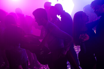 Celebration night at the club with dancing friends crowd and neon lights creating a vibrant party vibe