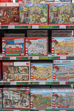 Hoogwoud, Netherlands &mdash; November 6, 2025: Store shelf display of &ldquo;Where&rsquo;s Wally?&rdquo; and Falcon de luxe jigsaw puzzles.