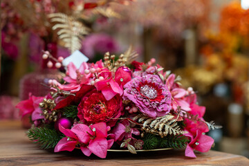 Pink and Gold Holiday Floral Centerpiece on Evergreen Base