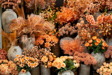 Warm Orange Floral Display in Rustic Stone Vases