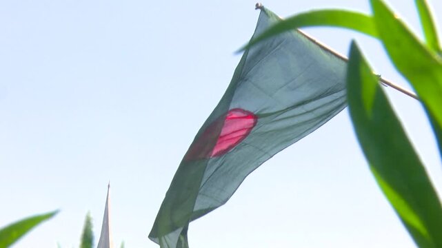 Bangladesh National Flag Waving Against Clear Blue Sky in Daylight