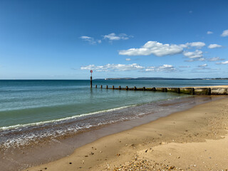 Sunny Bournemouth beach with pier and calm sea