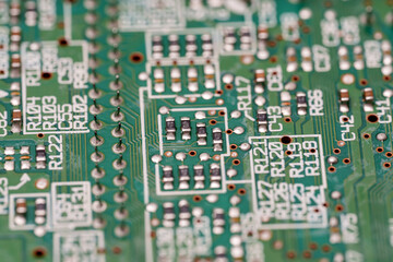 Intricate circuitry patterns illuminate the tiny world of a green Electronic motherboard