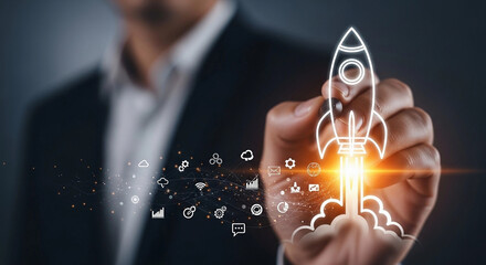Business man drawing a rocket with digital icons representing startup and innovation concept idea