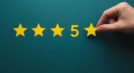 Hand placing the final yellow star to complete a five star rating on a dark green background