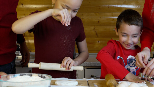 Brother and sister are baking Christmas cookies together. - Powered by Adobe