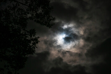 Fototapeta premium Mysterious Moon Behind Dark Clouds Night