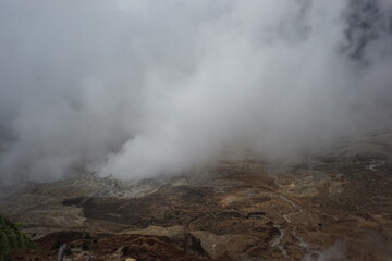 Ethereal Landscape A Misty Volcanic Field with Steaming Vents
