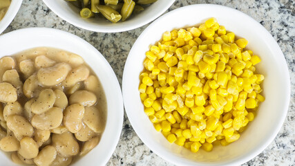 Freshly canned corn and beans ready to serve at a summer gathering in a cozy kitchen