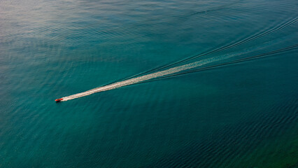 Tourists sailing on a pleasure boat at sea. Aerial view.