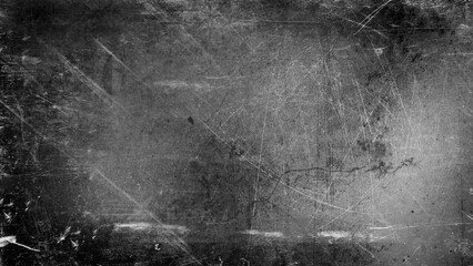 Abstract blurred grainy background with light and black scratches on gray.