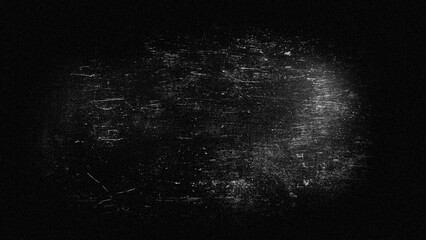 Abstract blurred grainy background, light scratches on dark gray in a black frame.
