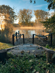 Wooden bridge in autumn park at sunrise